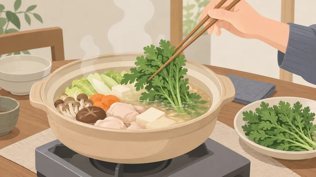 煮えている土鍋に菜箸で春菊を入れる手元
